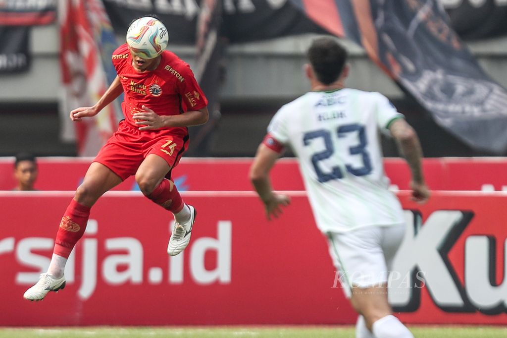 Bek Persija Jakarta (merah) Rizky Ridho Ramdhani menahan bola dengan sundulan dalam laga lanjutan BRI Liga 1 Indonesia 2023/2024 di Stadion Patriot Candrabhaga, Kota Bekasi, Jawa Barat, Sabtu (2/9/2023). 