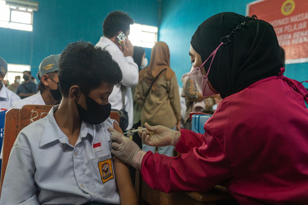 Vaksinator menyuntikkan vaksin jenis Sinovac ke seorang pelajar yang mengikuti vaksinasi massal di SMAN 2 Kendari, Sulawesi Tenggara, Senin (18/10/2021). Ratusan siswa mengikuti vaksinasi seiring kegiatan pembelajaran tatap muka yang berlangsung.