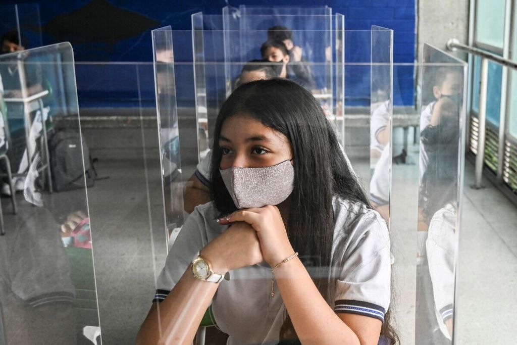 Para siswa belajar di sebuah kelas yang dilengkapi pelindung di Sekolah Negeri Antonio Jose Sucre di tengah pandemi Covid-19 di Itagui, Colombia, 25 Februari 2021.  
