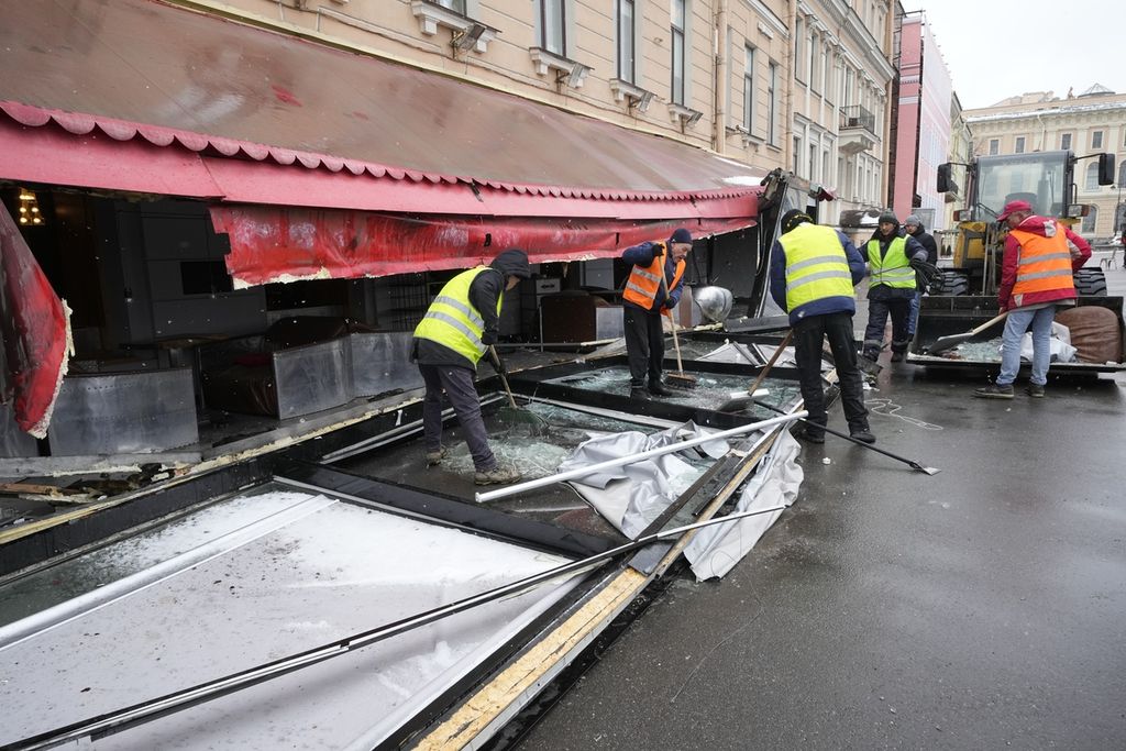 Sejumlah pekerja kota membersihkan area lokasi ledakan bom di kafe "Street Bar" di St. Petersburg, Rusia, Senin (3/4/2023). (AP Photo/Dmitri Lovetsky)