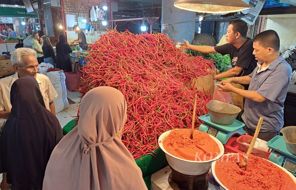 Pedagang mengambilkan cabai merah yang dipesan pembeli di Pasar Raya Padang, Kota Padang, Sumatera Barat, Senin (4/3/2024). 
