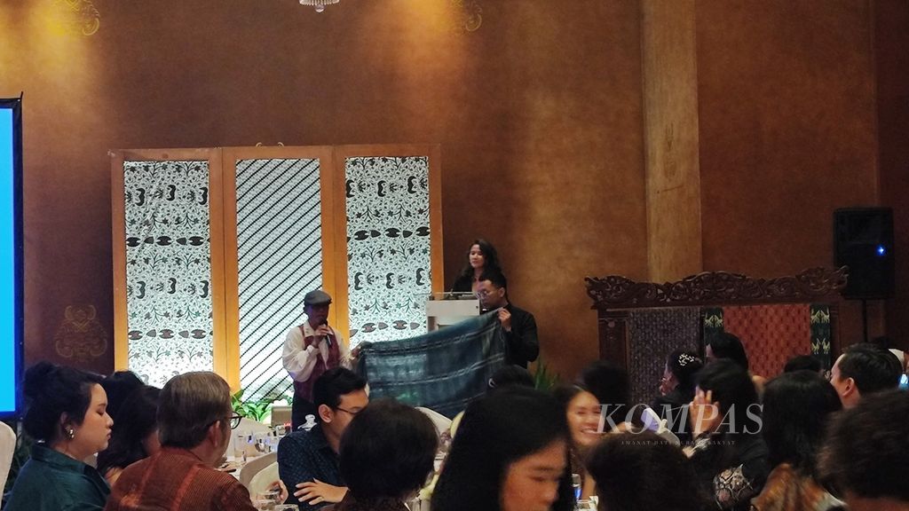 Fashion designer Merdi Sihombing explained the fabric he was auctioning, ulos mangiring, during the Fundraising Night Auction by the Loka Tari Nusantara Foundation and the Indonesian Dance Festival at The Dharmawangsa in Jakarta on Thursday (2/5/2024).
