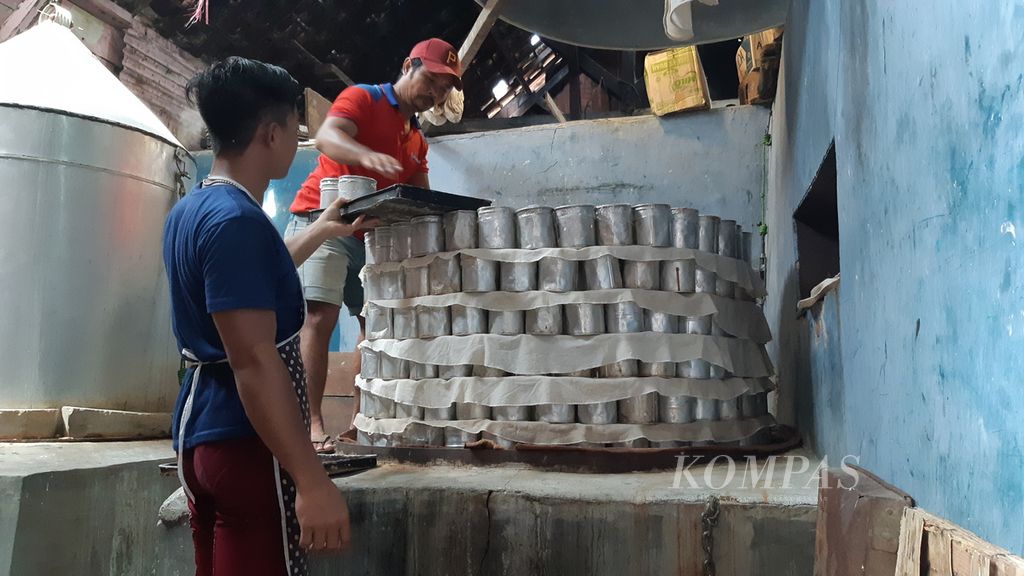 Pekerja sedang menata loyang berisi adonan kue keranjang di atas tungku di sebuah industri rumahan Kota Bandar Lampung, Lampung, Senin (16/1/2023). Jelang Imlek, pedagang kue keranjang di Bandar Lampung mendapat banyak pesanan kue keranjang. 