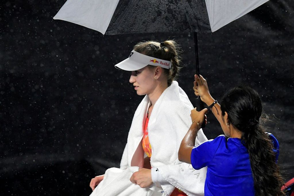 Petenis Kazakhstan, Elena Rybakina, dipayungi di tengah pertandingan babak grup turnamen Final WTA melawan petenis Belarus, Aryna Sabalenka, di Cancun, Meksiko, Jumat (3/11/2023) siang WIB. Pertandingan tersebut ditunda akibat faktor cuaca. 
