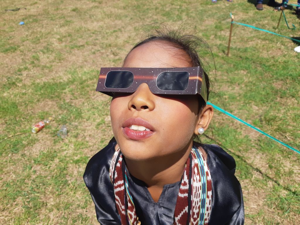 Seorang anak menyaksikan gerhana matahari total di Pulau Kisar, Kabupaten Maluku Barat Daya, Maluku, pada Kamis (20/4/2023). 