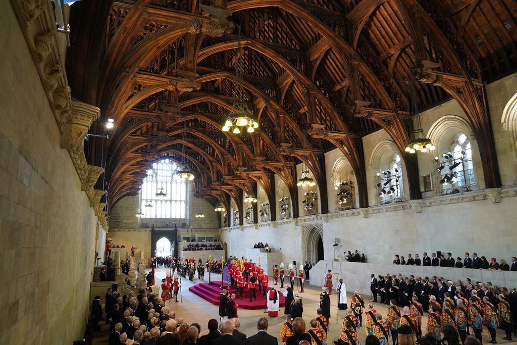 Para pengusung meletakkan peti jenazah Ratu Elizabeth II di Westminster Hall, London, 14 September 2022. Jenazah Ratu akan disemayamkan selama empat hari sebelum dimakamkan pada 19 September 2022. 