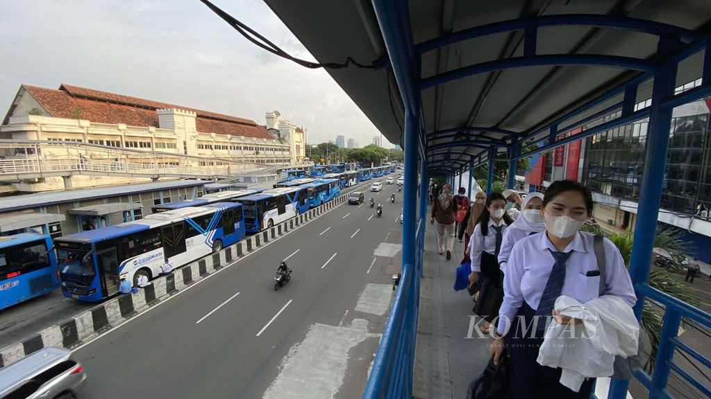 Warga menaiki tangga menuju halte bus Transjakarta di kawasan Harmoni, Jakarta Pusat, Senin (13/12/2021). Akhir-akhir ini bus Transjakarta tengah menjadi sorotan masyarakat akibat rentetan kecelakaan yang terjadi. Setidaknya ada lebih dari 500 kecelakaan yang melibatkan armada bus Transjakarta sepanjang Januari 2021 hingga mendekati akhir 2021. Kecelakaan Transjakarta belakangan ini menjadi momentum pembenahan manajemen keselamatan angkutan publik DKI Jakarta. Transjakarta bersama mitra operator mesti memberikan layanan berkualitas terhadap penumpang dan pemakai jalan.