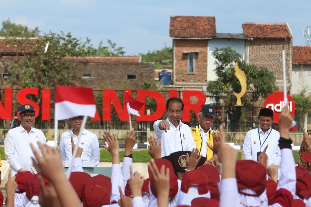 Presiden Joko Widodo memberikan pertanyaan kepada anak-anak yang meramaikan peresmian kolam retensi Andir, Kecamatan Baleendah, Kabupaten Bandung, Jawa Barat, Minggu (5/3/2023).