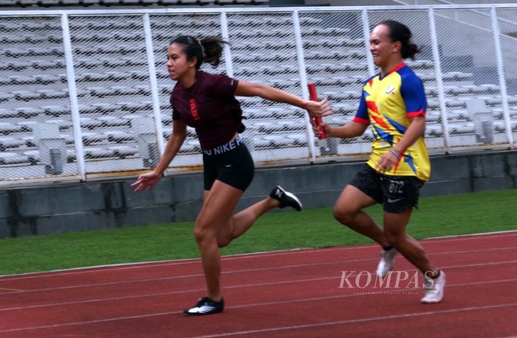 Pelari putri Valentine Vanesa Lonteng mengoper tongkat estafet kepada rekannya, Jeany Nuraini, saat menjalani latihan estafet 4 x 100 meter di pelatnas atletik di Stadion Madya Senayan, Jakarta, Jumat (8/4/2022). 