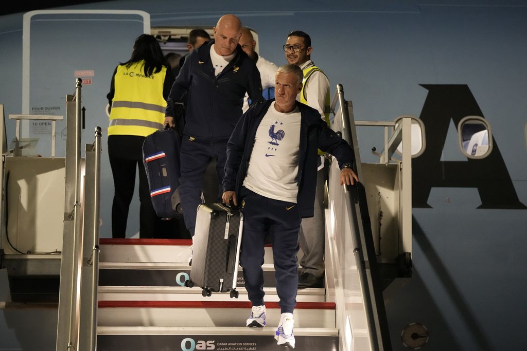 France's national team coach Didier Deschamps, right, arrives with his team at Hamad International airport in Doha, Qatar, Wednesday, Nov. 16, 2022, ahead of the upcoming World Cup. France will play their first match in the World Cup against Australia on Nov. 22. 