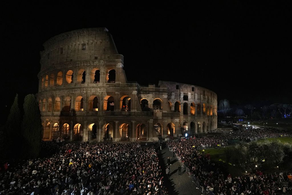 Umat memadati area depan Koloseum selama prosesi obor Via Crucis (Jalan Salib) pada Jumat Agung di Roma, Italia, Jumat (29/3/2024). 