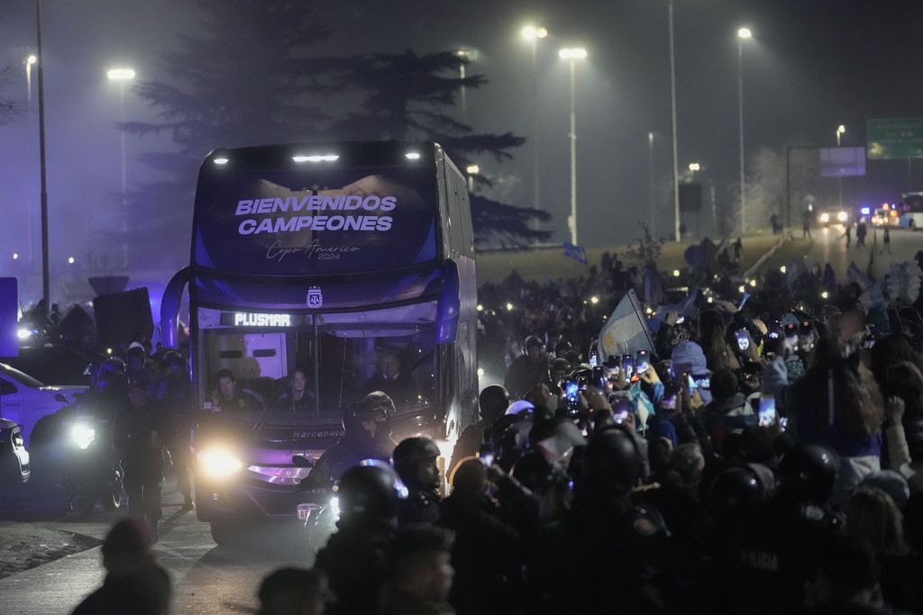 Bus yang membawa pemain dan ofisial tim Argentina yang menjuarai  Copa America melintasi jalan saat tiba di Buenos Aires, Argentina, Senin (15/7/2024) malam waktu setempat atau Selasa siang WIB.