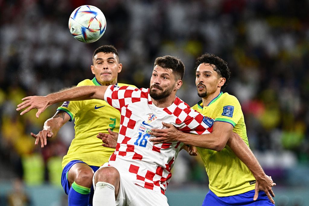 Croatia's forward #16 Bruno Petkovic fights for the ball with Brazil's defender #03 Thiago Silva and Brazil's defender #04 Marquinhos during the Qatar 2022 World Cup quarter-final football match between Croatia and Brazil at Education City Stadium in Al-Rayyan, west of Doha, on December 9, 2022. 