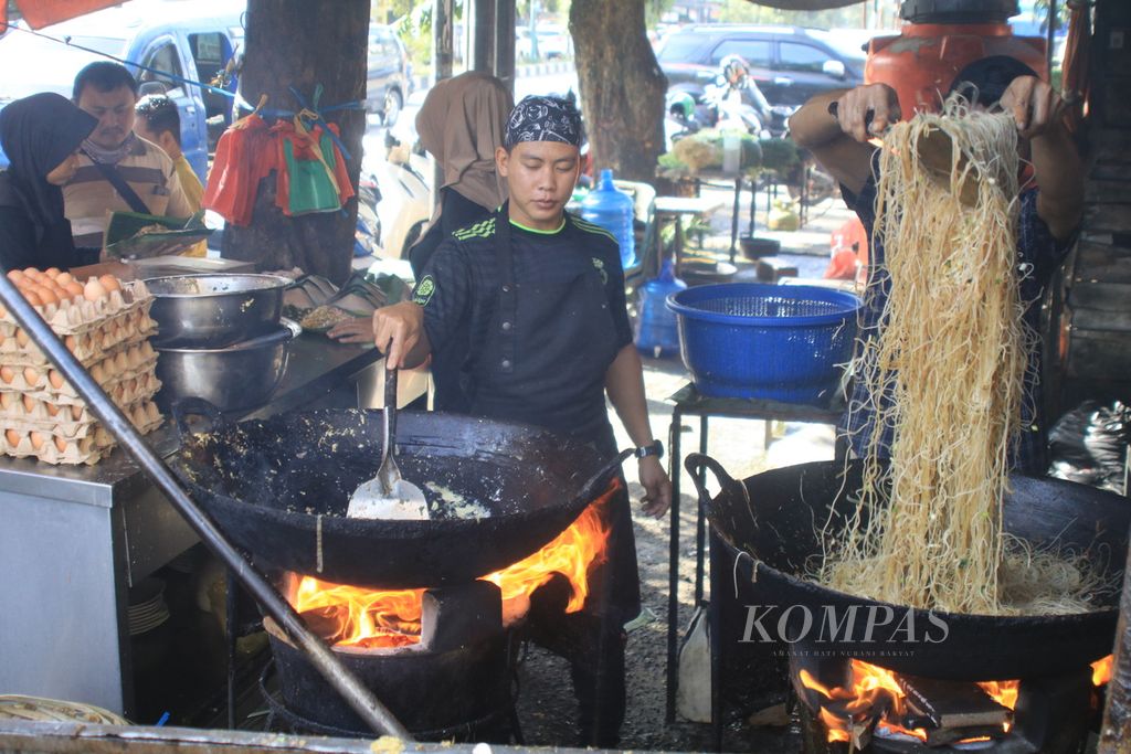 Juru masak menggoreng mi balap dengan kuali besar dan kayu bakar di Mi Balap Mail di Jalan Krakatau, Medan, Sumatera Utara, Jumat (3/11/2023). 