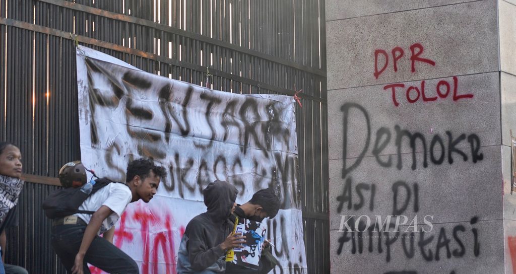 Coretan di gerbang Gedung DPR RI, Jakarta, saat puluhan lintas elemen masyarakat menggelar unjuk rasa menentang revisi UU Pilkada yang melawan putusan MK, Senin (26/8/2024). 