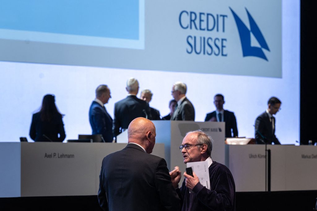 Para pemegang saham tengah berbincang dengan latar belakang para anggota dewan pada akhir rapat umum akhir tahun Credit Suisse di Zurich pada Selasa (4/4/2023).