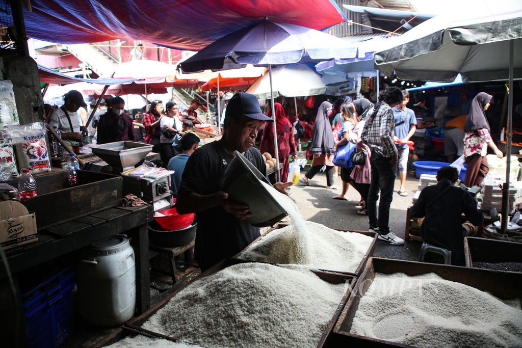 Pekerja menambah stok beras di toko beras di Pasar Kebayoran Lama, Jakarta Selatan, Selasa (13/2/2024). Kenaikan harga beras tidak hanya dirasakan oleh konsumen, tetapi juga oleh pedagang karena kesulitan menjual akibat harganya yang tinggi.