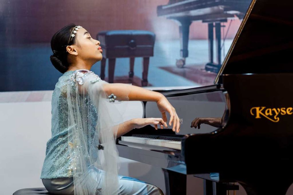 Nayla Arifa Salwa hanyut dalam melodi piano yang ia mainkan.