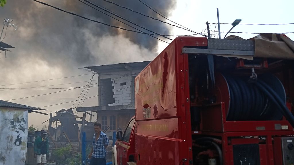 Mobil pemadam kebakaran parkir di simpang jalan Kapuk Utara 2, Kapuk Muara, Penjaringan, Jakarta Utara. Di kawasan itu, ratusan rumah semipermanen ludes terbakar pada Minggu (30/7/2023).