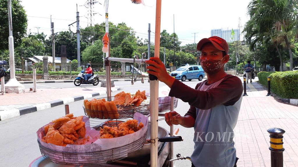  Iwang (40), pedagang gorengan, menjajakan dagangannya di sekitar Stasiun Palmerah, Jakarta Pusat, Rabu (2/11/2020).