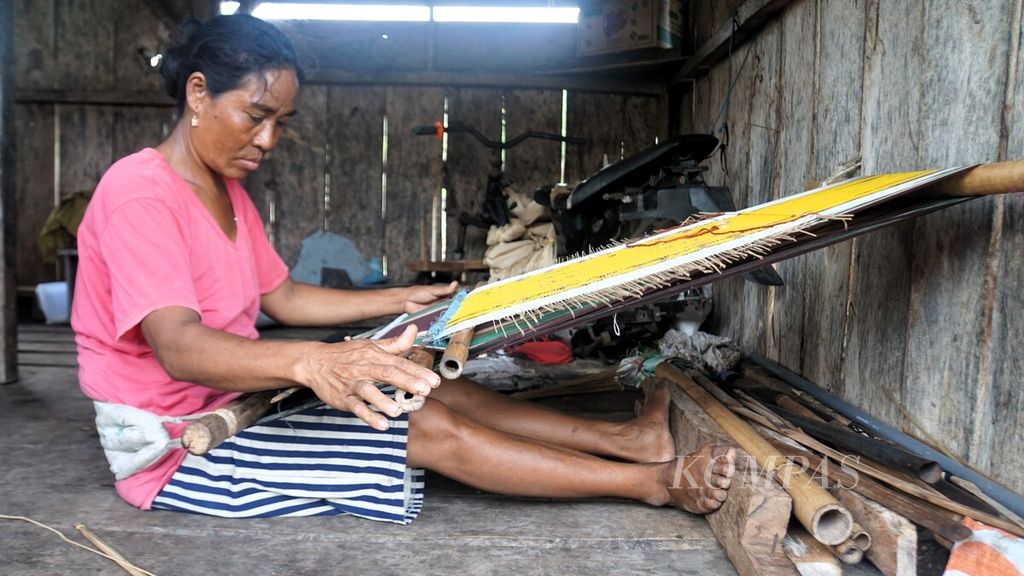 Ibu-ibu suku Sumba menenun kain tenun Sumba di rumahnya di Kampung Patanning, Desa Rindi, Sumba Timur, Selasa (9/1/2024).