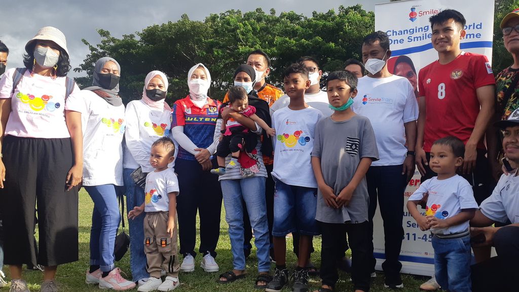 Pesepak bola Witan Sulaiman (baju merah) berpose bersama anak-anak bibir sumbing dan pekerja sosial dari Smile Train di Kota Palu, Sulteng, Jumat (14/1/2022). Penyandang bibir sumbing masih mendapat perundungan di masyarakat.