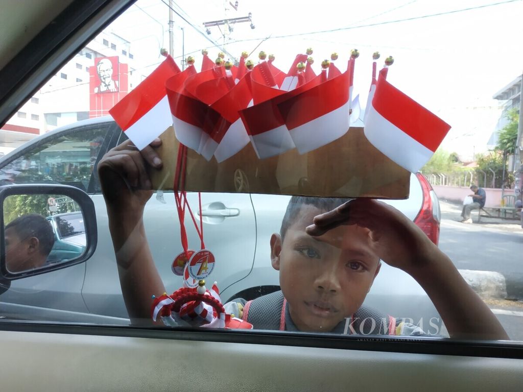 Anak-anak berjualan di Jalan H Adam Malik, Medan, Sumatera Utara, Senin (8/7/2019). Banyak anak dari keluarga miskin kota turun ke jalan untuk berjualan membantu ekonomi keluarga.