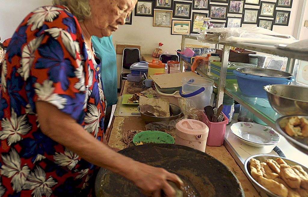 Giok Tju (87) menyiapkan numbu rujak cingur di Warung Rujak Cingur Achmad Jais di Surabaya, Jumat (11/8). Warung Rujak Cingur tersebut telah ada sejak 1970.