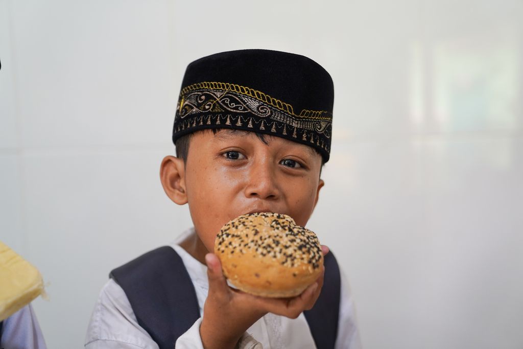 Anak sekolah dasar menikmati roti kiriman Foodcycle di Lembaga Nur Sahabat, Kelurahan Kampung Melayu, Jakarta Timur, DKI Jakarta, Jumat (10/11/23).