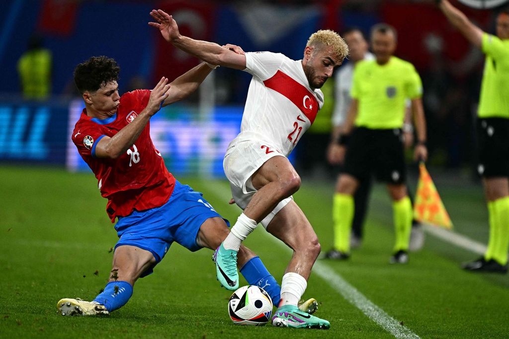 Bek Ceko, Ladislav Krejci, dan penyerang Turki, Baris Alper Yilmaz, berebut bola dalam pertandingan Grup F antara Ceko dan Turki di Volksparkstadion, Hamburg, Kamis (27/6/2024) dini hari WIB. 