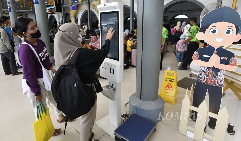 Penumpang kereta api jarak jauh melakukan pencetakan boarding pass secara mandiri di Stasiun Pasar Senen, Jakarta, Selasa (25/4/2023). 