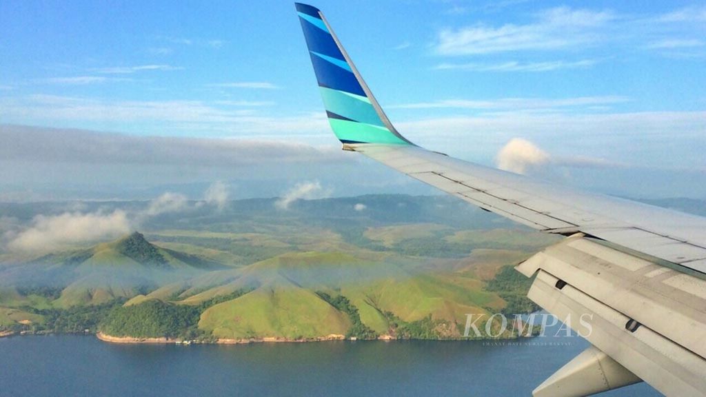 Pesawat Garuda Indonesia sedang terbang di atas Danau Sentani sebelum mendarat di Bandar Udara Sentani, Jayapura, 9 Juni 2019.