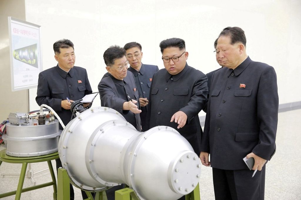 Pemimpin Korea Utara Kim Jong Un (keempat dari kiri) menyampaikan pengarahan, bersama Ri Hong Sop (kedua dari kiri) dan Hong Sung Mu (kanan), mengenai program senjata nuklir dalam foto tanpa tanggal yang dirilis kantor berita Korea Utara, Korean Central News Agency (KCNA), di Pyongyang, Korut, pada 3 September 2017.