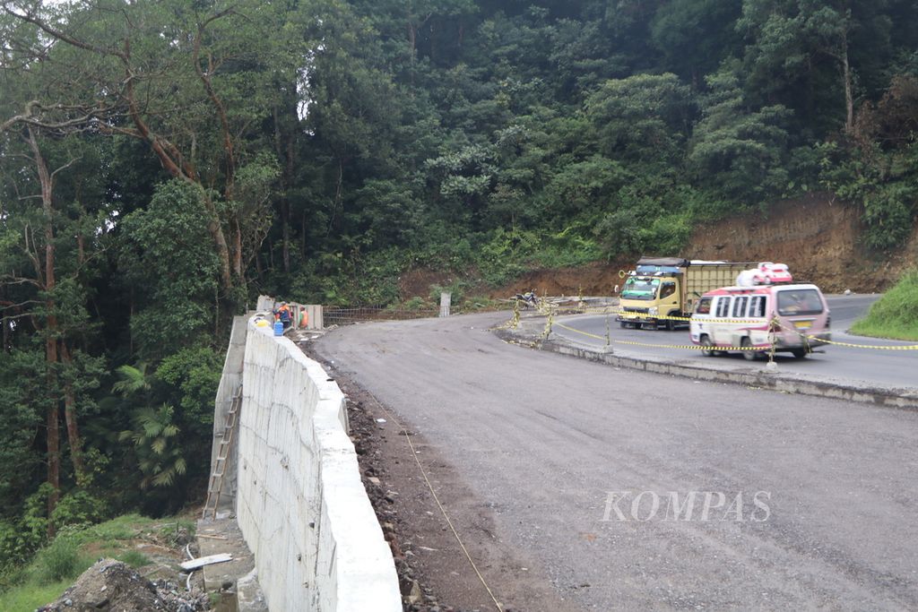 Kendaraan melintas di tikungan tajam di Jalan Medan-Berastagi di Kecamatan Sibolangit, Kabupaten Deli Serdang, Sumatera Utara, Selasa (24/5/2022). Jalan diperlebar di tikungan tajam yang rawan kecelakaan itu.