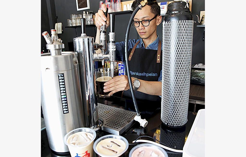 Abe, barista di Kopi Kebut meracik kopi dengan campuran gas nitrogen.