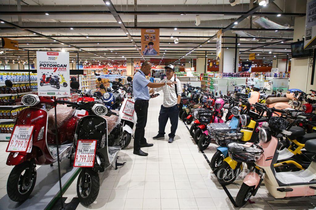 Pengunjung mendengarkan penjelasan pramuniaga sepeda listrik di supermarket ritel Transmart di Jakarta, Rabu (8/11/2023).