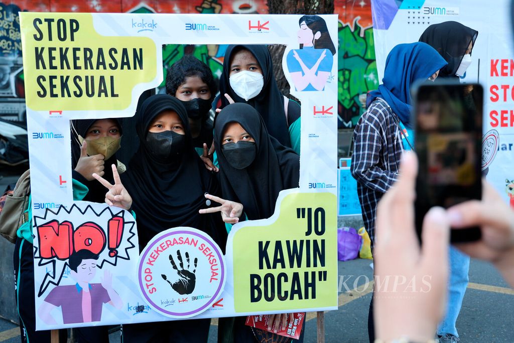 Anak-anak berfoto di antara bingkai yang berisi pesan untuk menghentikan berbagai bentuk kekerasan pada anak di Jalan Slamet Riyadi, Kota Surakarta, Jawa Tengah, Minggu (24/7/2022). Fenomena kekerasan anak saat ini terjadi dari lingkungan keluarga, pertemanan, hingga sekolah.