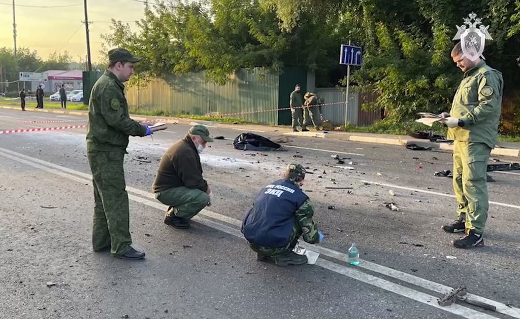 In this handout photo taken from video released by Investigative Committee of Russia on Sunday, Aug. 21, 2022, investigators work on the site of explosion of a car driven by Daria Dugina outside Moscow. Daria Dugina, the daughter of Alexander Dugin, the Russian nationalist ideologist often called "Putin's brain", was killed when her car exploded on the outskirts of Moscow, officials said Sunday. The Investigate Committee branch for the Moscow region said the Saturday night blast was caused by a bomb planted in the SUV driven by Daria Dugina. (Investigative Committee of Russia via AP)