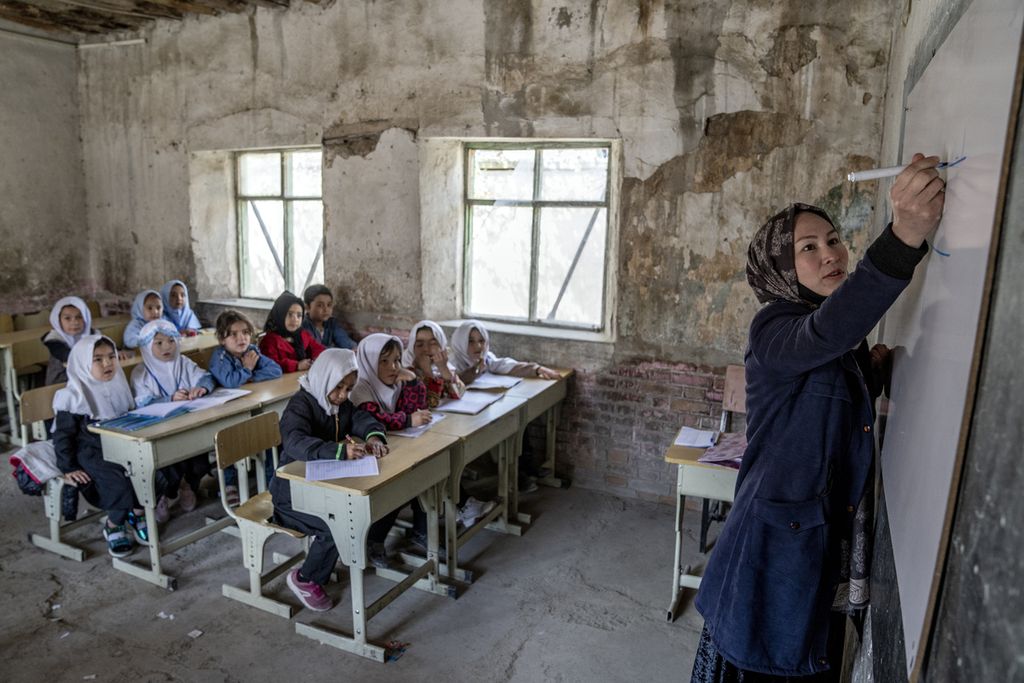 A teacher teaches a class of girls on the first day of the new school year in Kabul, Afghanistan, March 25, 2023. 