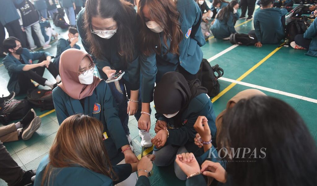 Mahasiswa baru Universitas Surabaya (Ubaya) memamerkan gelang persahabatan yang baru dibuat dari sampah kertas dan plastik saat Masa Orientasi Bersama (MOB) di Kota Surabaya, Jawa Timur, Sabtu (20/8/2022).