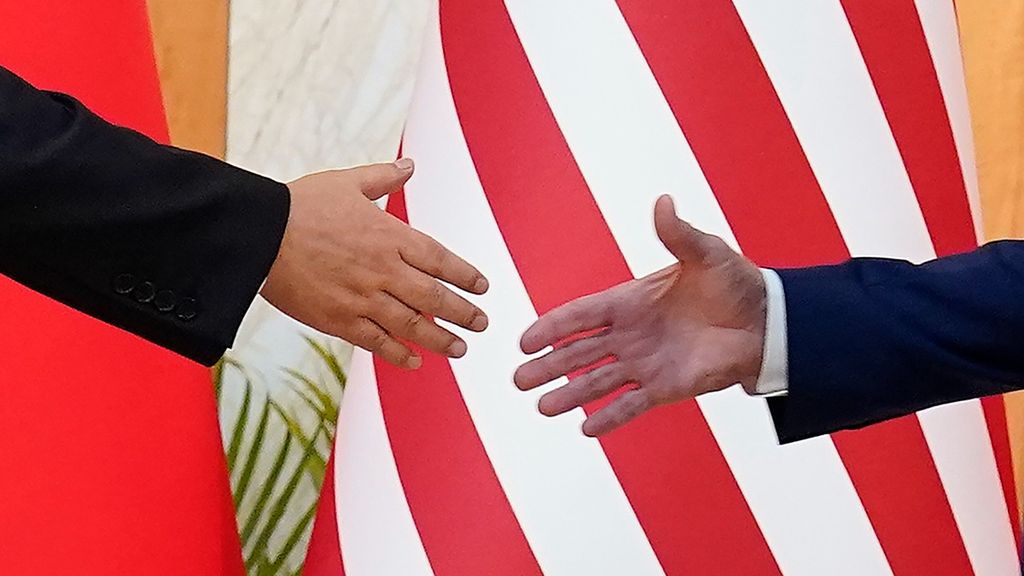 U.S. President Joe Biden (right) and Chinese President Xi Jinping reach out to shake hands before their meeting on the sidelines of the G20 summit meeting, on Monday, Nov. 14, 2022, in Nusa Dua, in Bali, Indonesia. 