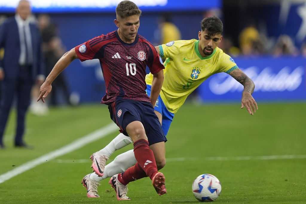 Pemain Kosta Rika, Brandon Aguilera (kiri), dan pemain Brasil, Lucas Paqueta, berebut bola saat pertandingan Copa America Grup D antara Brasil dan Kosta Rika di Selasa (25/6/2024), di Stadion SoFi, Los Angeles. 