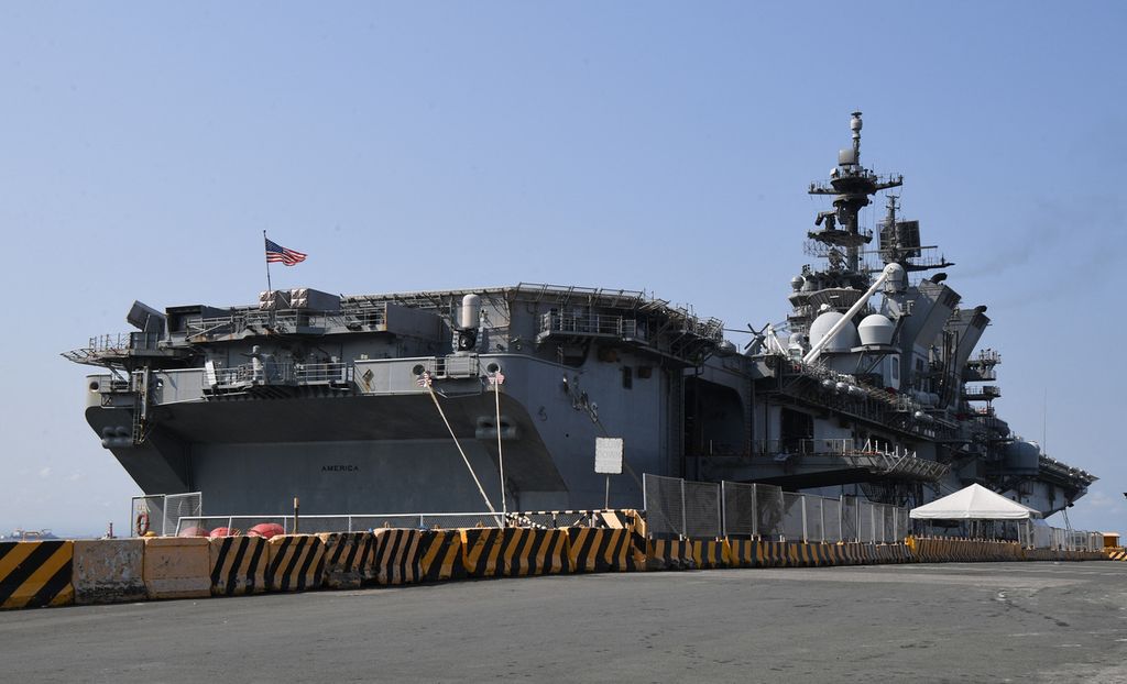 Bendera Amerika Serikat dikibarkan di dek penerbangan kapal serbu amfibi USS America yang berlabuh di pelabuhan internasional di Manila, Filipina, Selasa (21/3/2023). 