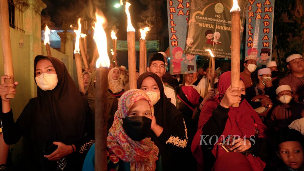 Warga mengikuti Festival Pawai Obor mengelilingi Kampung Bojong Tua, Jatimakmur, Pondok Gede, Kota Bekasi, Jawa Barat, Kamis (30/3/2022). Pawai obor yang diikuti oleh ratusan pelajar, komunitas dan warga sekitar tersebut diselenggarakan untuk menyambut bulan suci Ramadhan. 