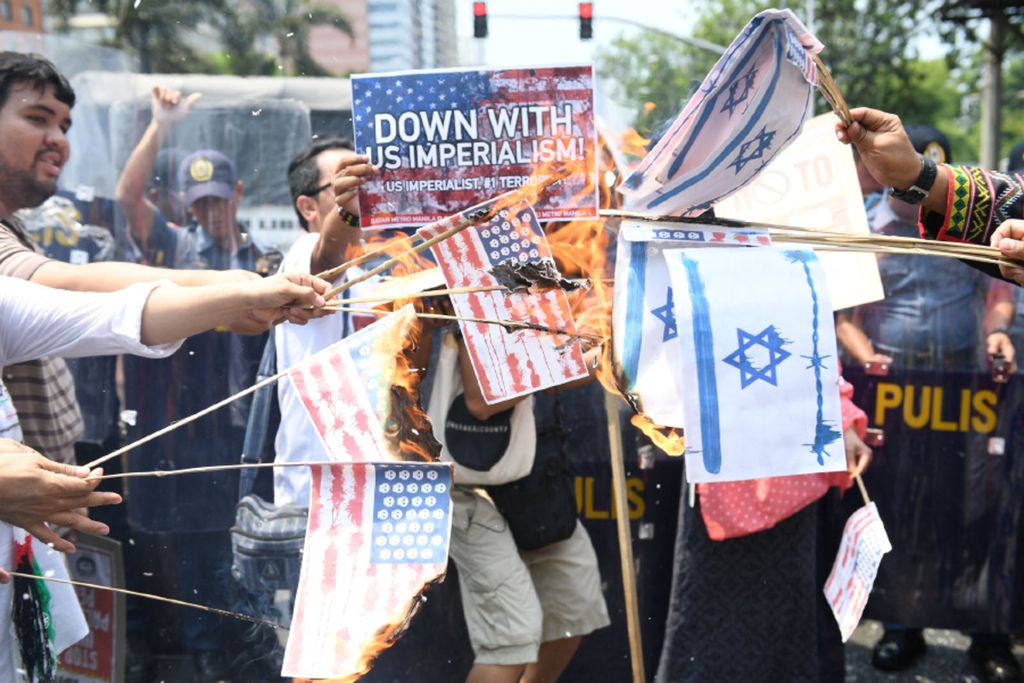 Muslim activists hold mock US flags during a rally on May 17 supporting the Palestinian cause near the US Embassy in Manila, the Philippines. At least 2,400 Palestinians were injured and some 60 others, including children, were shot and killed by Israeli soldiers as they gathered to demonstrate along the borders of the Gaza Strip enclave to protest the transfer of the US embassy from Tel Aviv to Jerusalem.