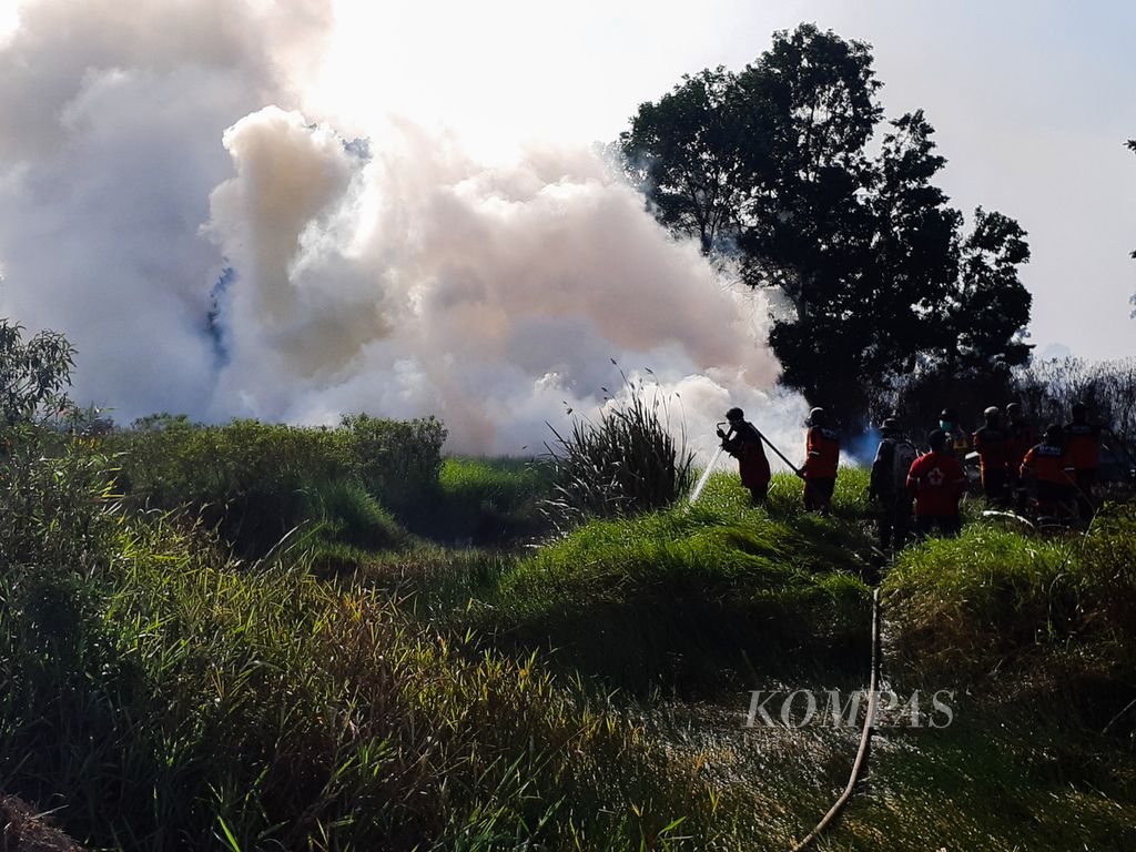 Petugas satgas penanggulangan karhutla Sumsel sedang memadamkan sebuah titik api yang terletak di Desa Talang Pengeran Ilir, Kecamatan Pemulutan Barat, Kabupaten Ogan Ilir, Sumatera Selatan, Jumat (28/8/2020). Di sepanjang 2020, kebakaran lahan di Sumsel sudah menghanguskan 95,5 hektar lahan.