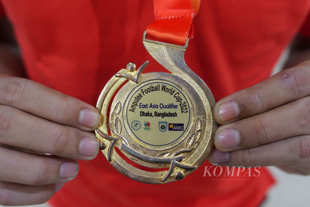 Pemain timnas sepak bola amputasi Indonesia memperlihatkan bentuk medali peserta Piala Dunia Sepak Bola Amputasi 2022 di Turki pada pertemuan dengan Menteri Pemuda dan Olahraga Zainudin Amali di Gedung Kemenpora, Jakarta, Kamis (17/3/2022). 