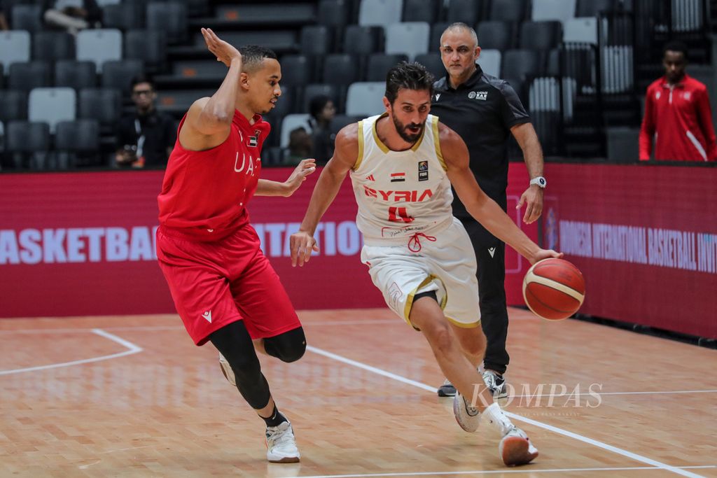 Pemain Suriah, Nadim Issa, melewati pemain Uni Emirat Arab, Mohammad Abudllateef Abreiki, pada pertandingan kedua Indonesia International Basketball Invitational (IIBI) di Stadion Indonesia Arena, Jakarta, Rabu (2/8/2023). UEA menang, 63-61. 