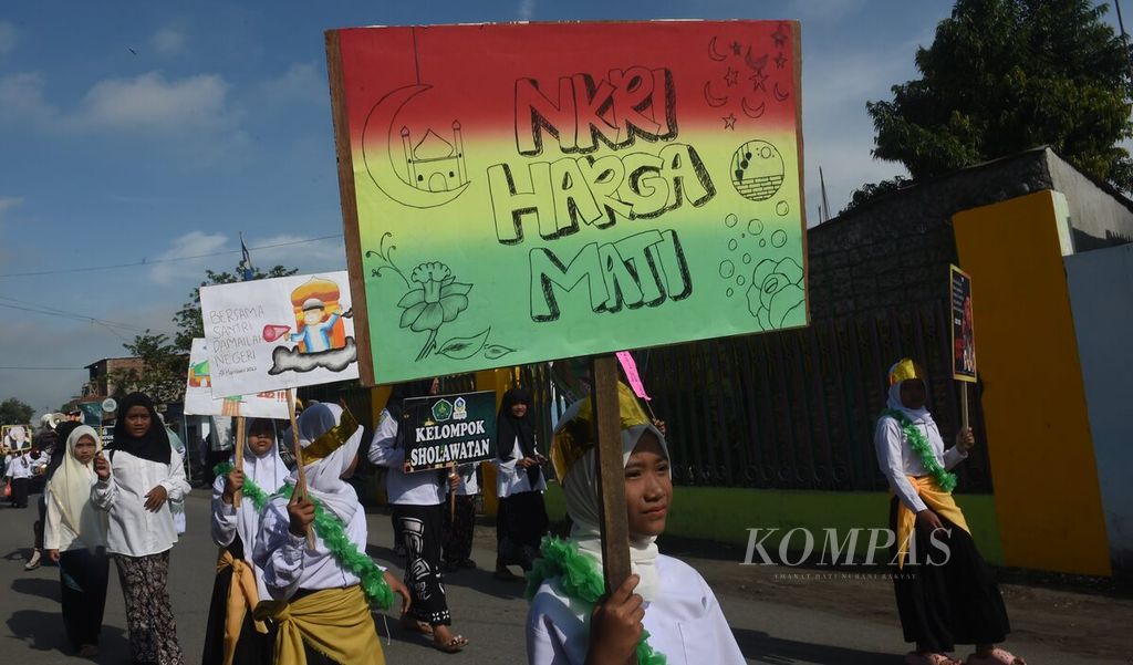 Santri membawa poster saat pawai Hari Santri Nasional di Kecamatan Diwek, Kabupaten Jombang, Jawa Timur, Sabtu (22/10/2022). 