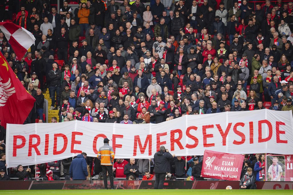 Suporter Liverpool membentangkan spanduk dalam pertandingan derbi Merseyside antara Liverpool dan Everton di Stadion Anfield, Liverpool. Sabtu (21/10/2023). Liverpool memetik kemenangan dengan dua gol tanpa balas. 